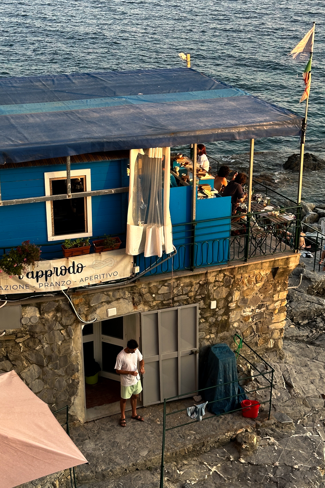 Outdoor tables of L’Approdo restaurant overlooking the sea in Bogliasco, Italy