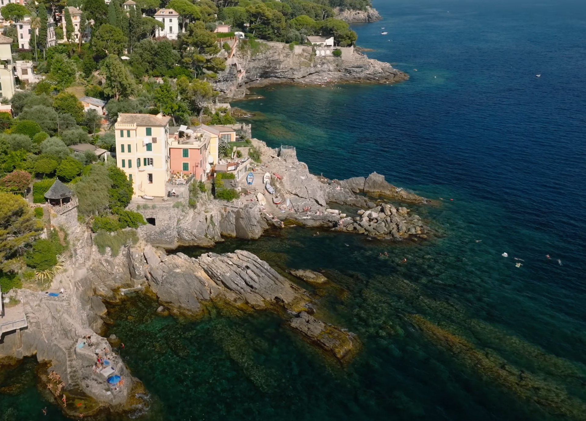 Drone view of Bogliasco’s coastline with pastel houses and rocky shore