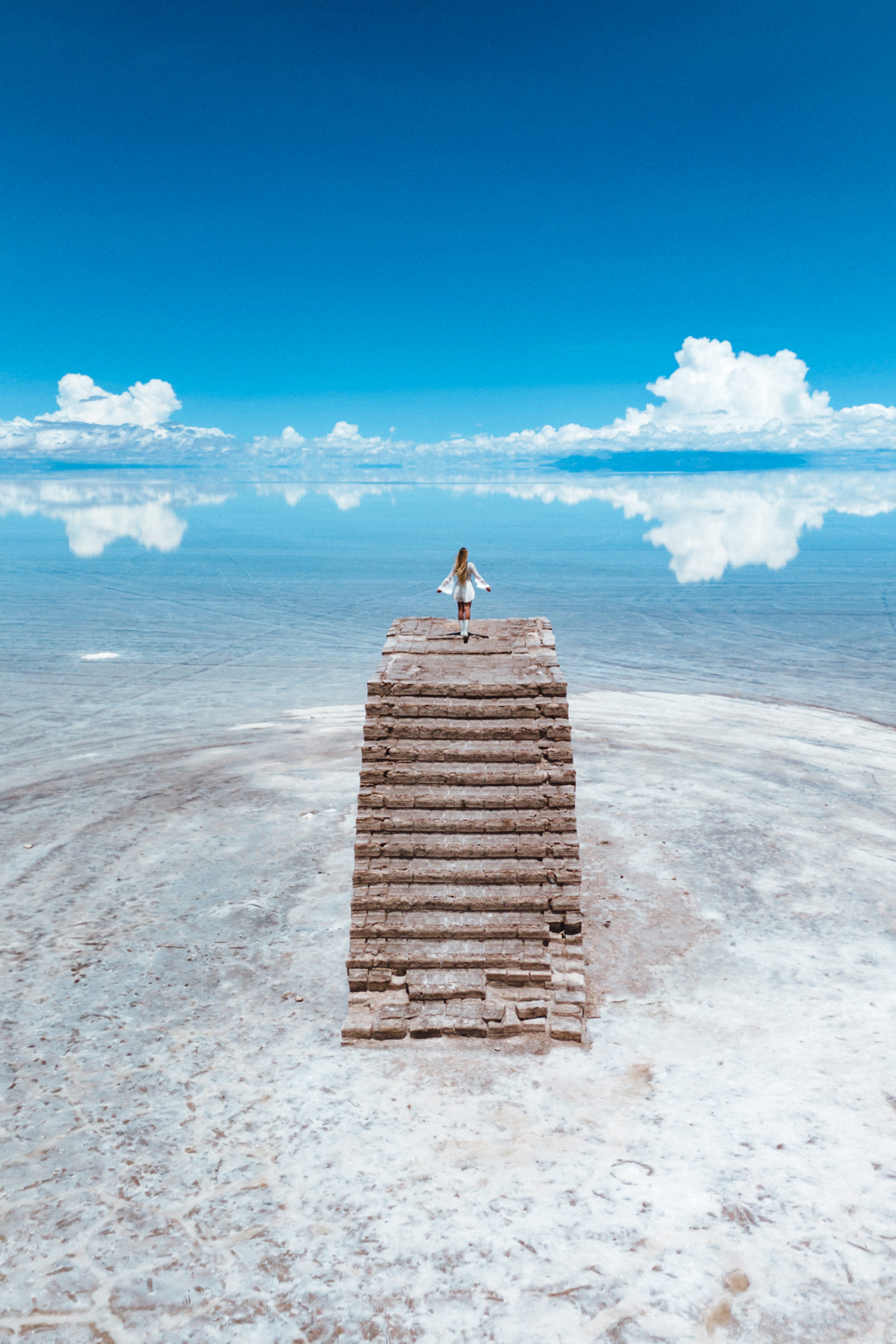 Uyuni Salt Flats Woman standing on top of salt brick stairs at Uyuni Salt Flats, Bolivia