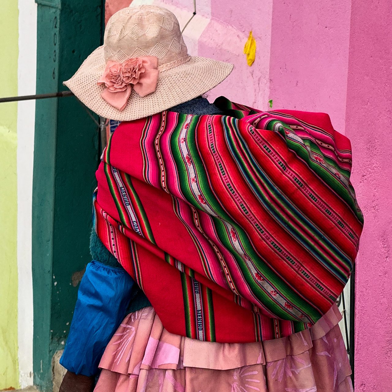 Culture in Bolivia Indigenous Bolivian woman wearing traditional skirt and red aguayo shawl
