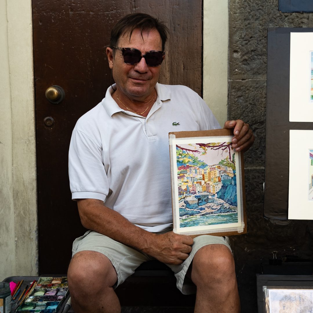 Culture in Itay Artist showing his colorful painting in Florence, Italy.