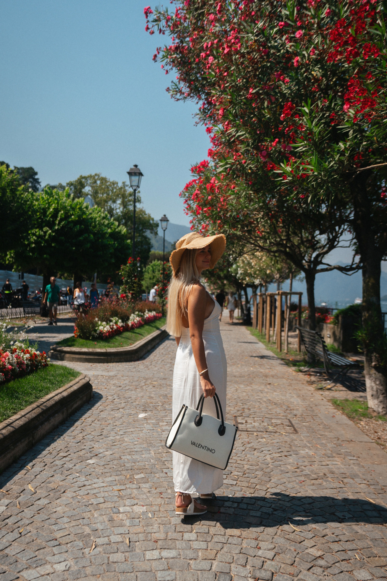 Walking along the flower-lined promenade of Bellagio by Lake Como.