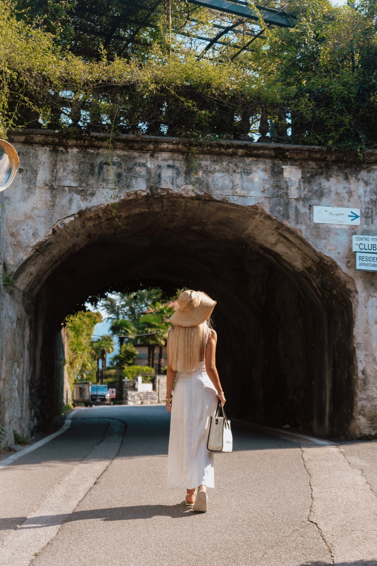 Walking through an old stone archway in Bellagio by Lake Como.