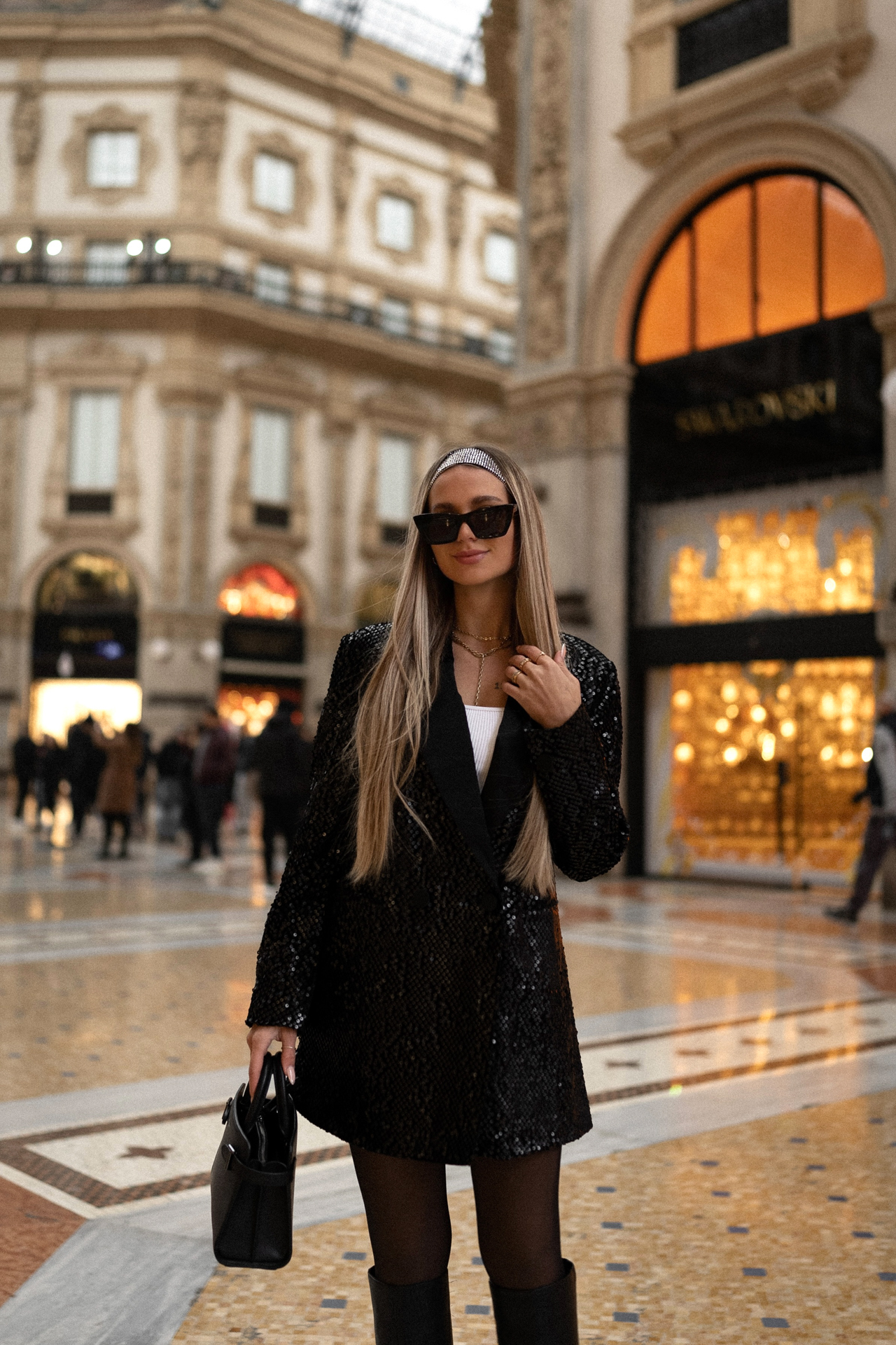 Stylish woman standing inside Galleria Vittorio Emanuele II, Milan’s historic shopping arcade