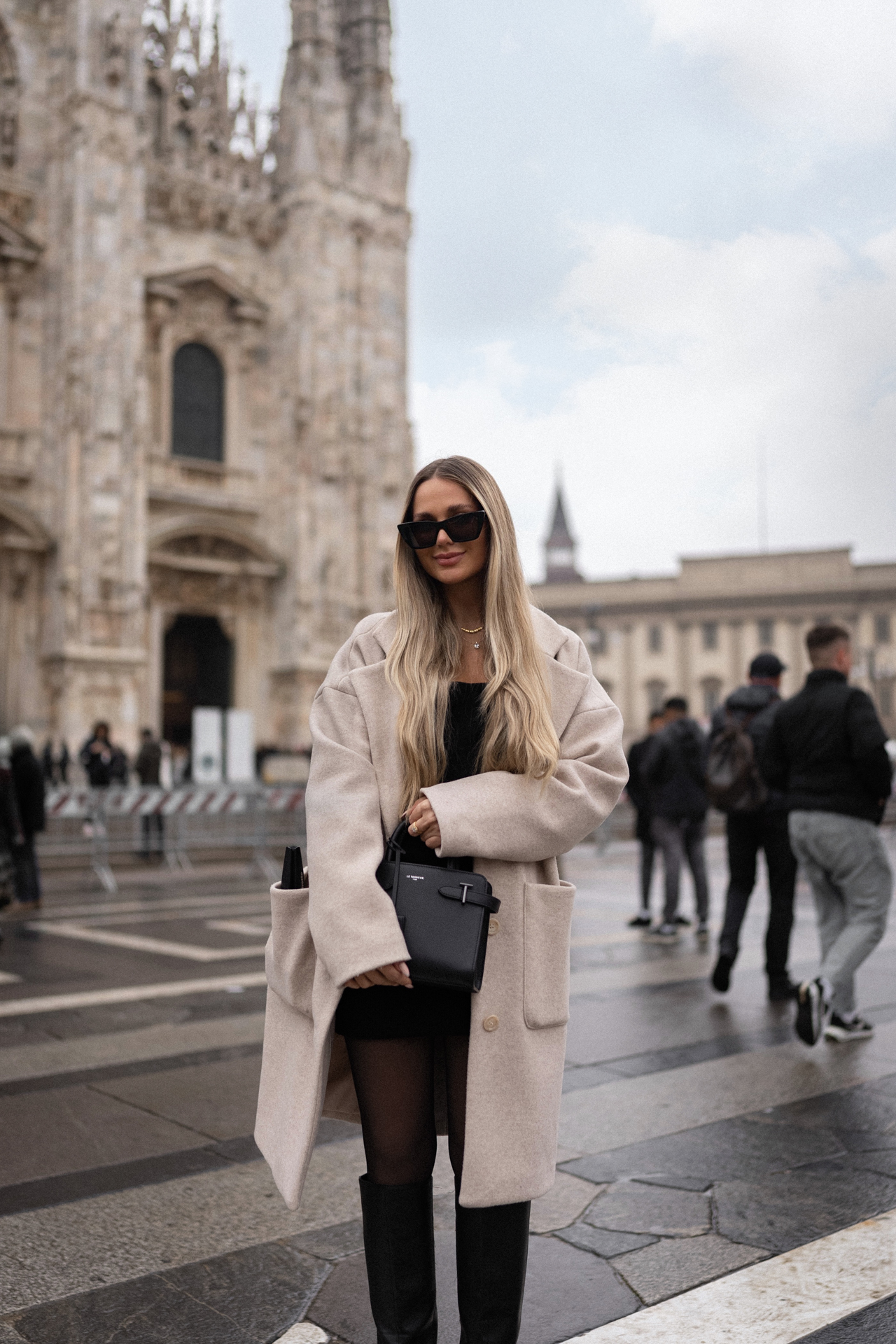 Woman posing in front of Milan Cathedral, iconic Duomo di Milano, Italy travel.