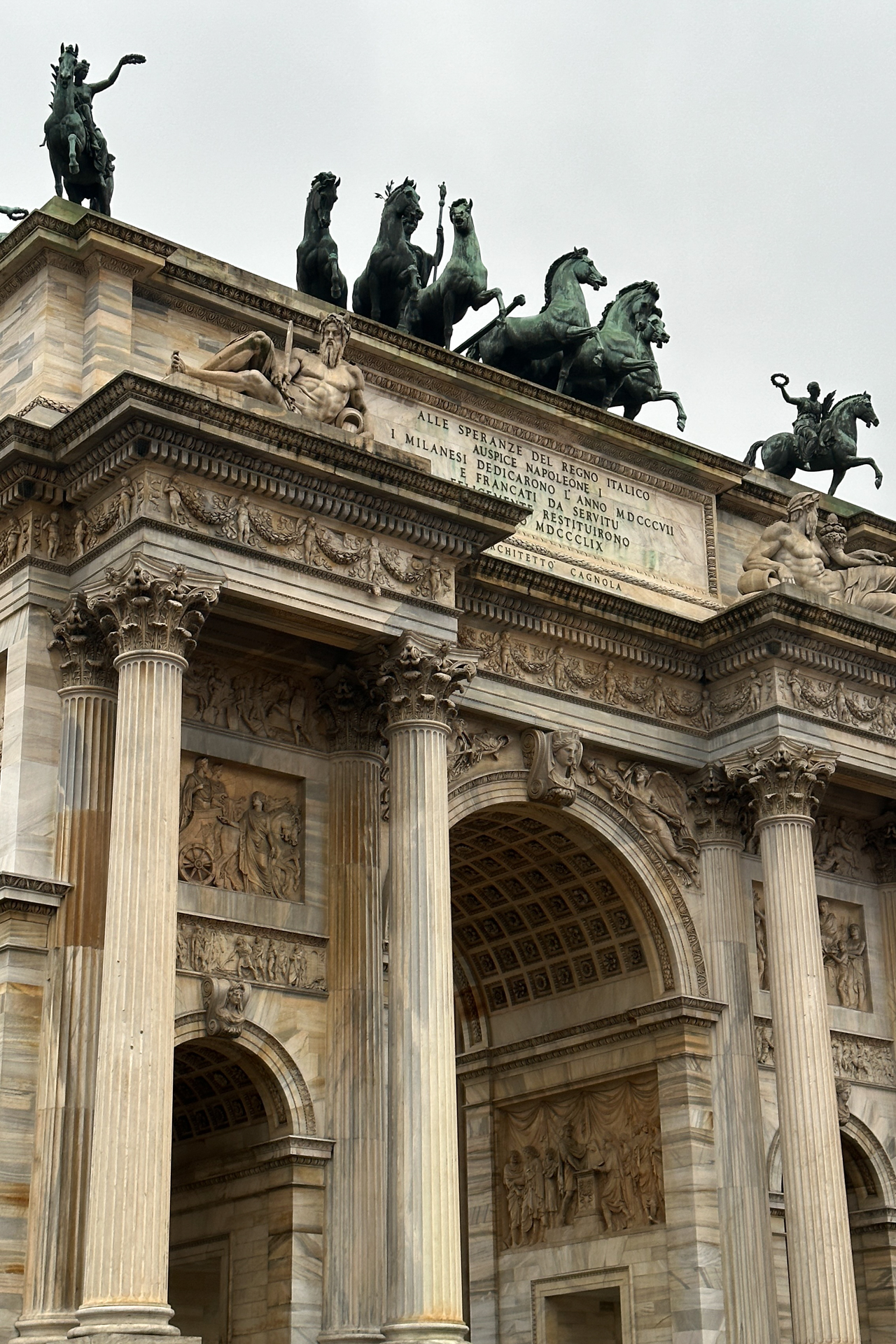 Detailed view of the Arco della Pace with statues and horse sculptures on top in Milan, Italy