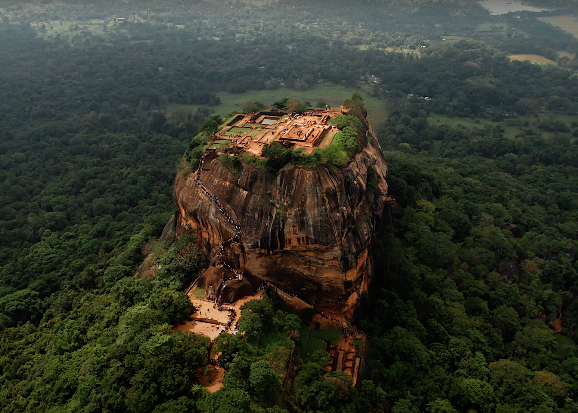 Aerial view of Sigiriya Rock Fortress in Sri Lanka, showing the ancient ruins on top of the massive rock.