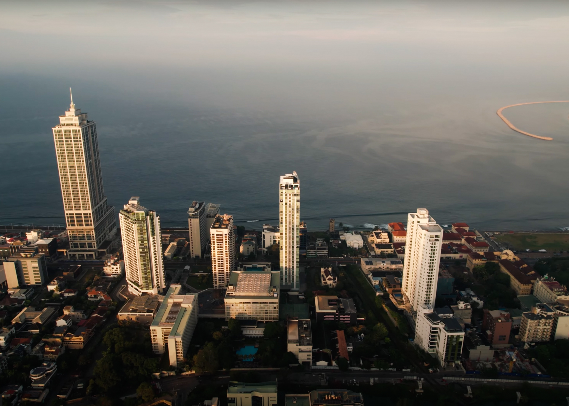 Aerial view of Colombo city skyline with tall buildings by the Indian Ocean, Sri Lanka.