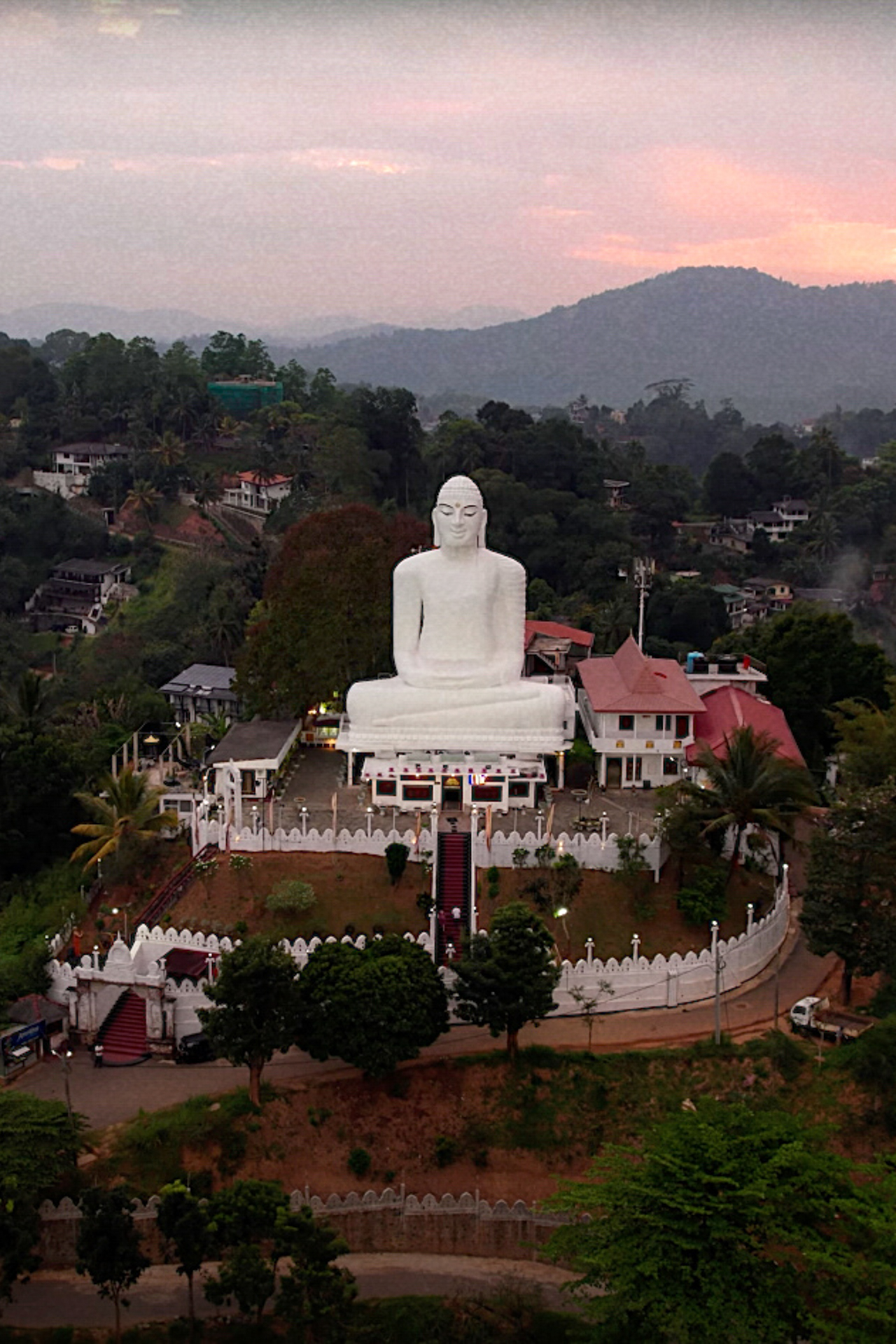 Aerial view of the Bahirawakanda Vihara Buddha statue in Kandy, Sri Lanka, at sunset.