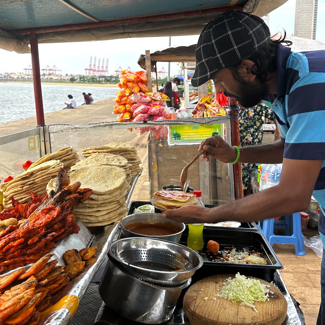 Food in Sri Lanka Sri Lankan street food vendor preparing roti at a stall by the sea in Colombo, Galle Face Green