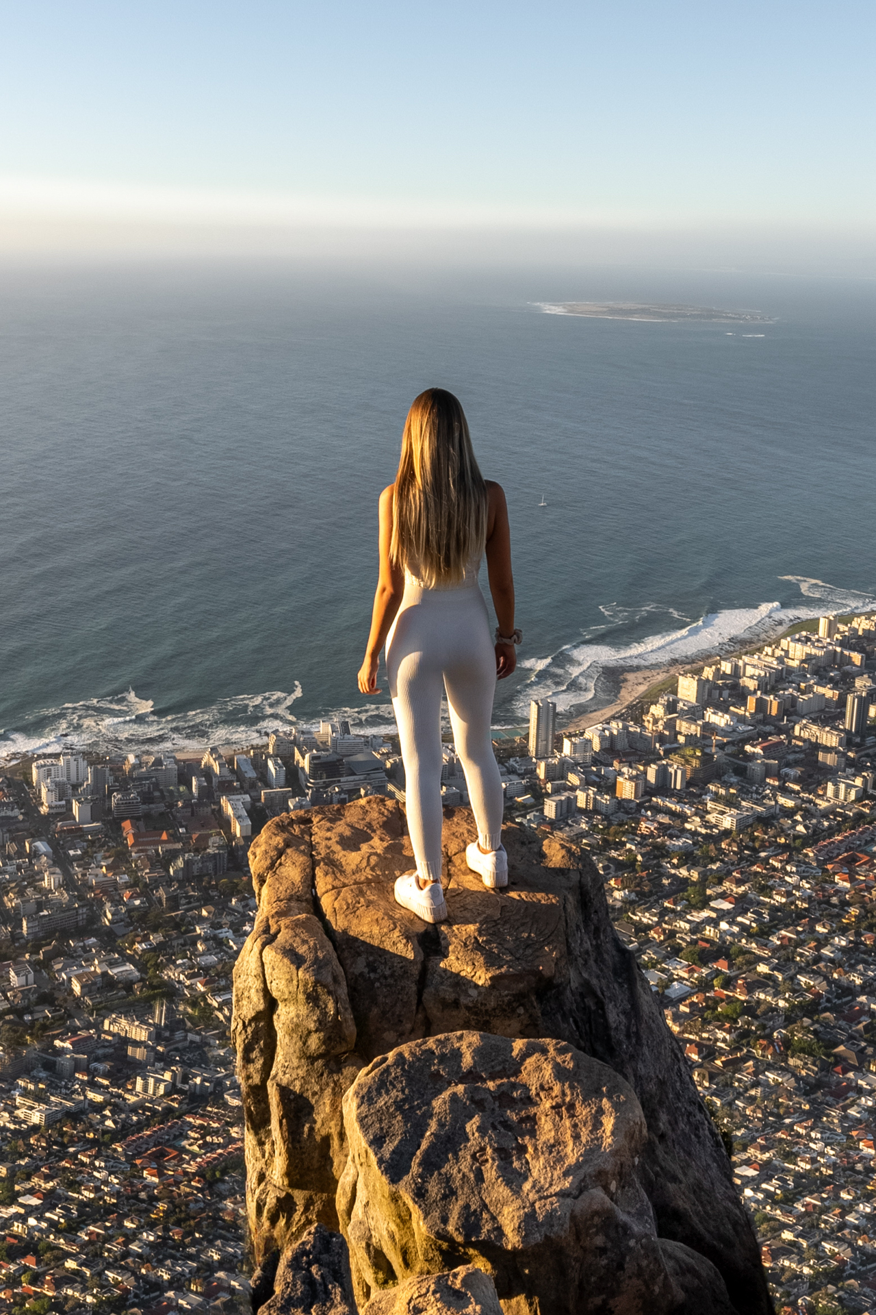 Lion's Head Woman standing on top of Lion's Head looking over Cape Town.