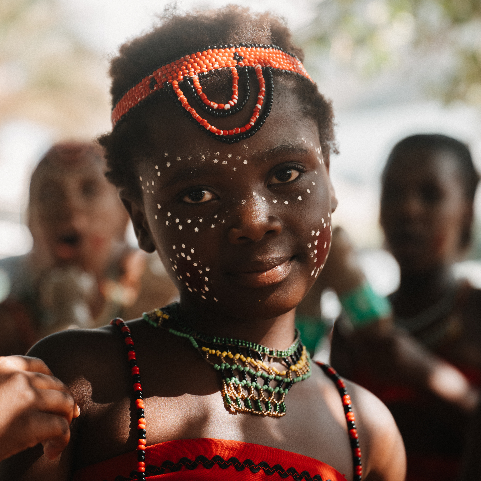 Culture in Cape Town Young girl in cultural attire with beaded jewelry and painted face from Cape Town.