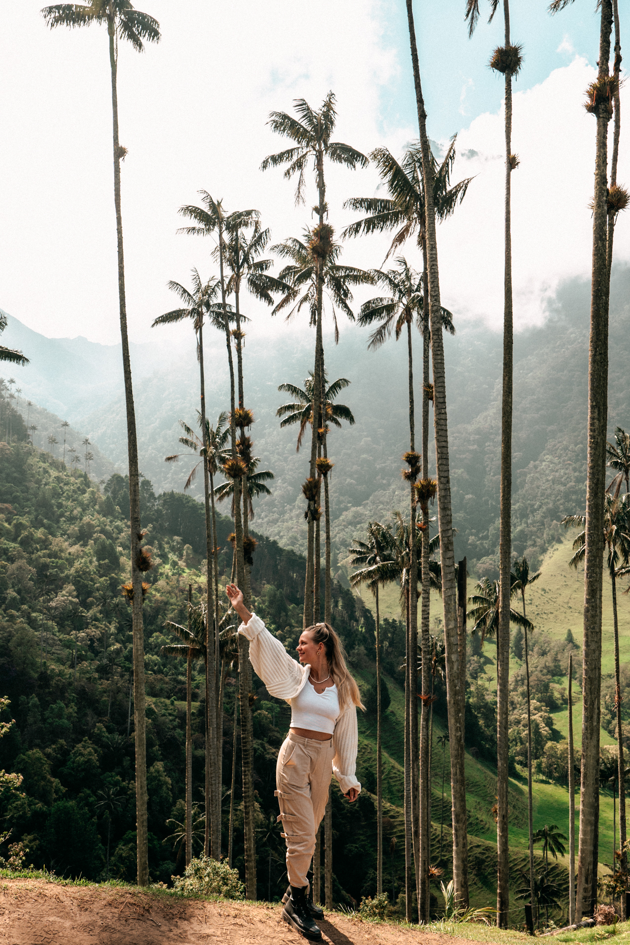 Salento Traveler posing among the towering wax palm trees in the Cocora Valley, Colombia.