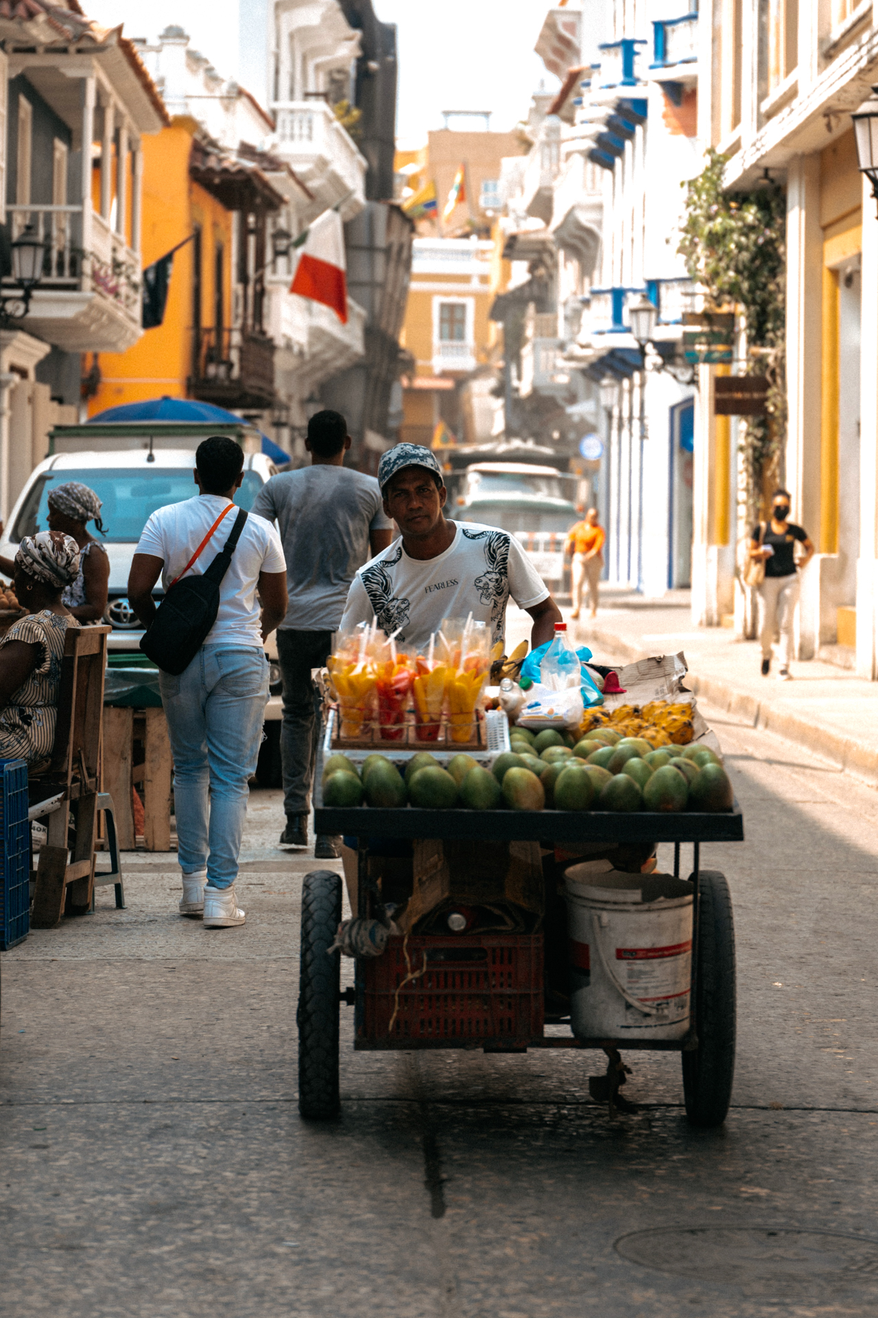 Cartagena Street vendor pushing a fruit cart through the colorful colonial streets of Cartagena, Colombia.