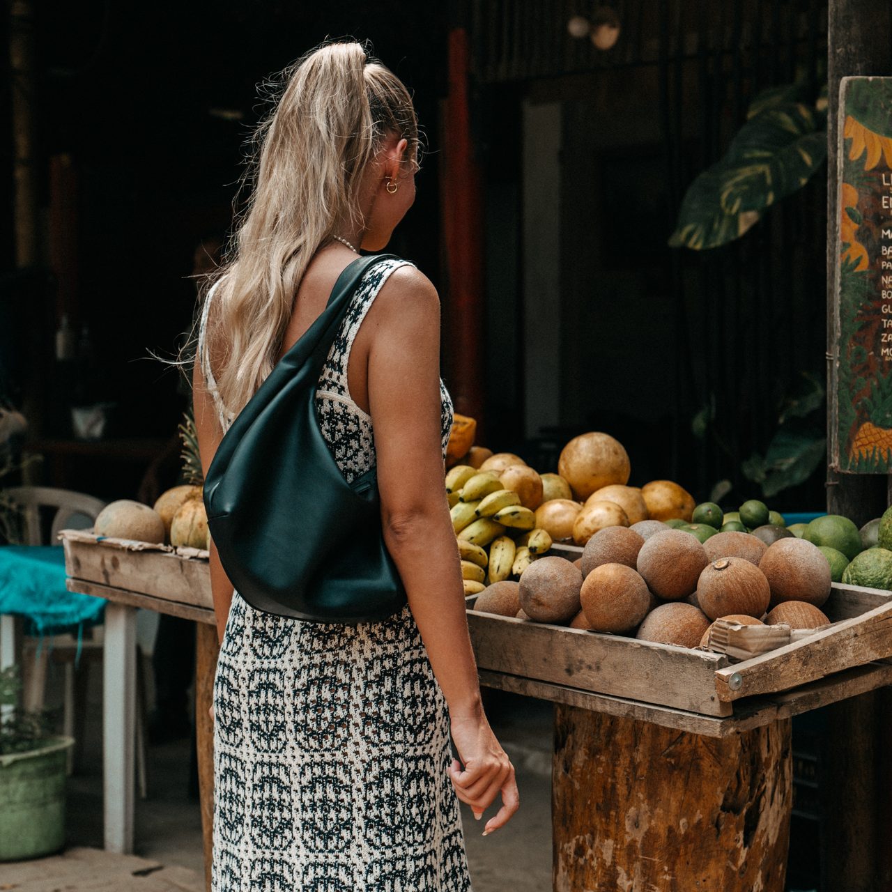 Food in Colombia Woman browsing tropical fruits at a local market stall in Colombia, Palomino