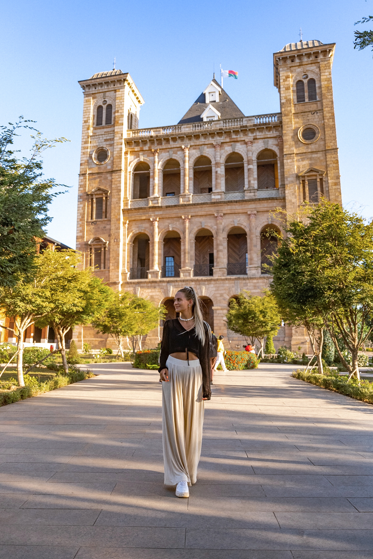 Antananarivo Woman walking in front of the Rova of Antananarivo, Madagascar’s historic royal palace.