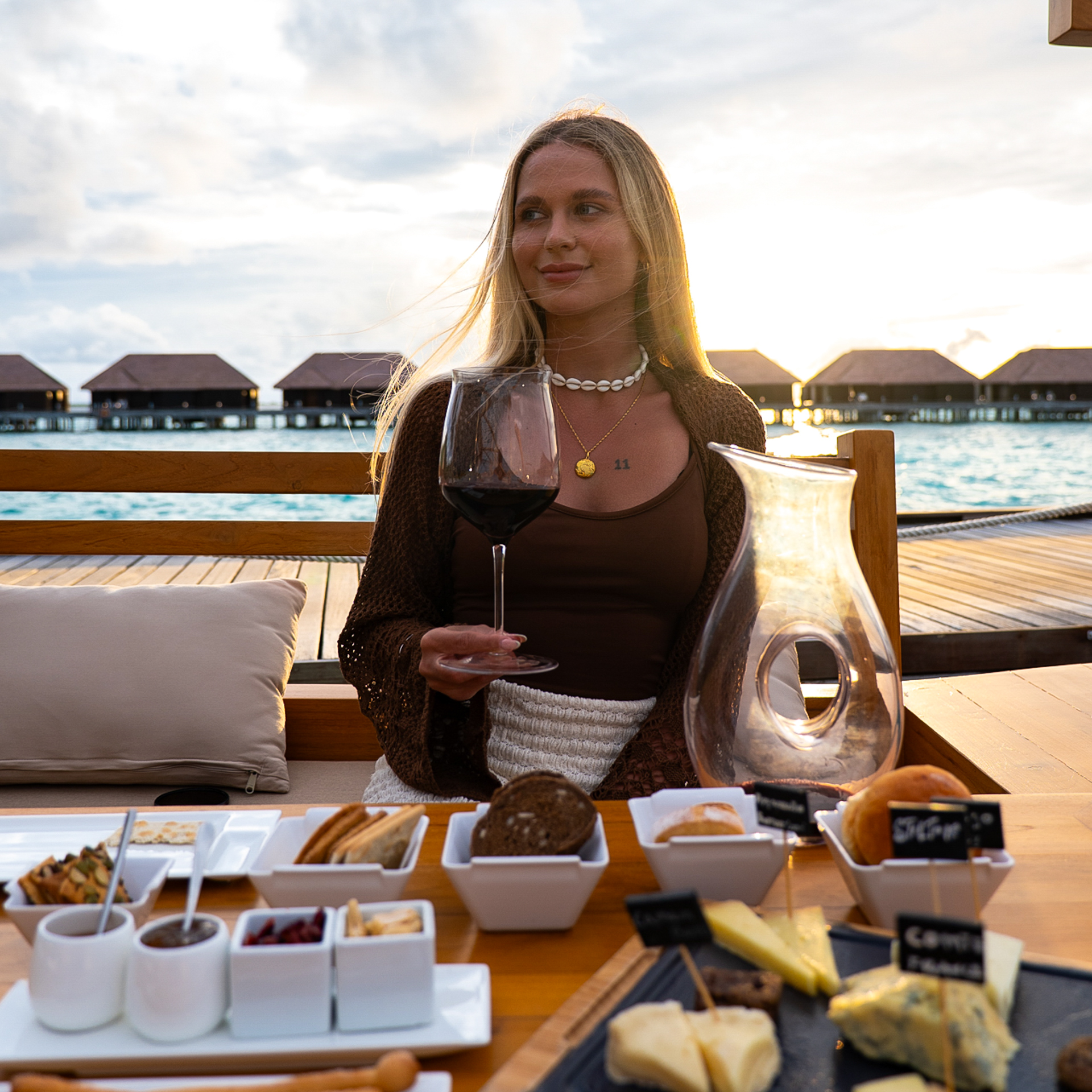 Food in the Maldives Woman enjoying wine and cheese at a seaside resort in the Maldives.