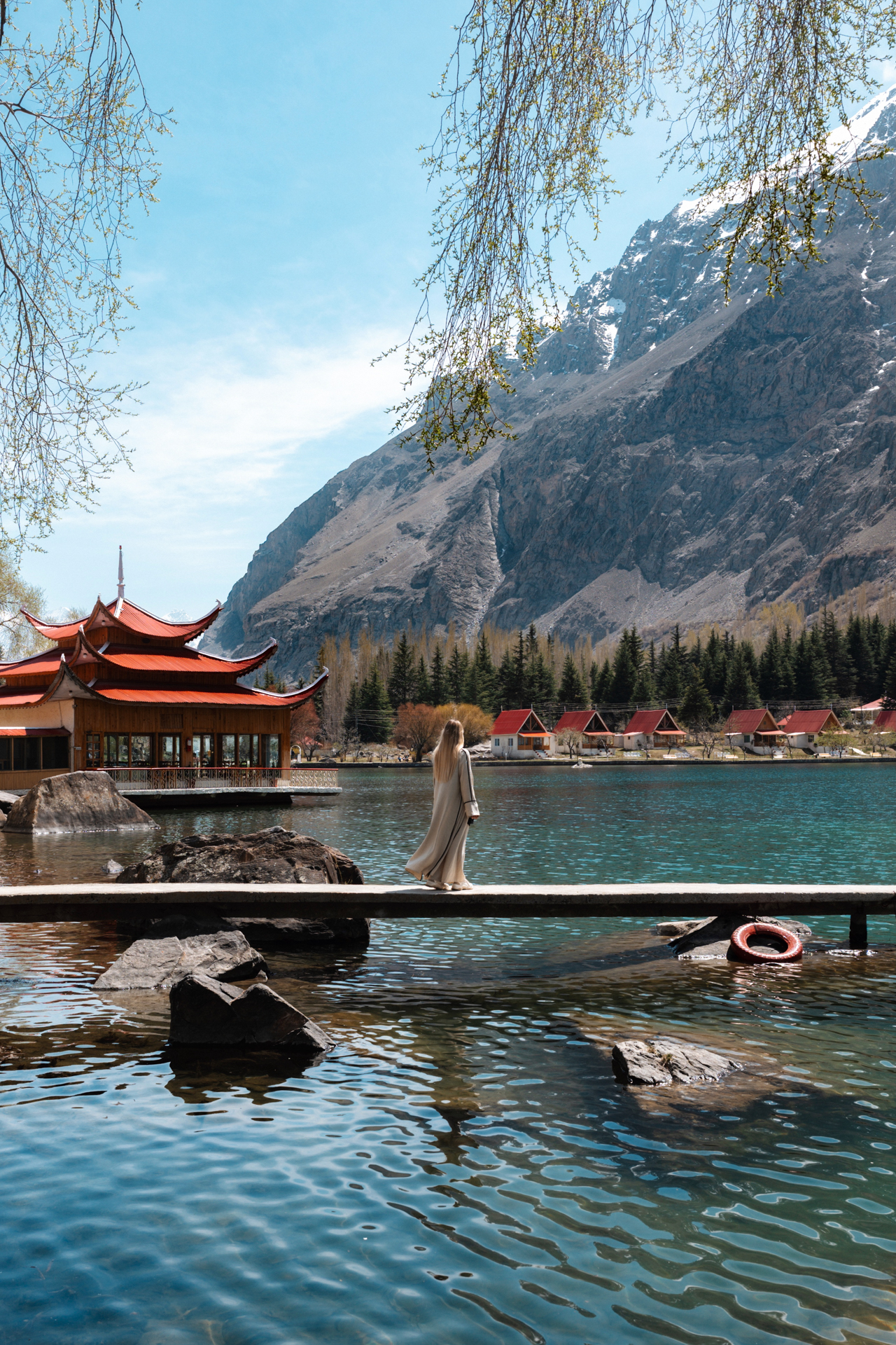 Shangrila Resort lake Shangrila Resort lake with woman walking by the water in Pakistan.