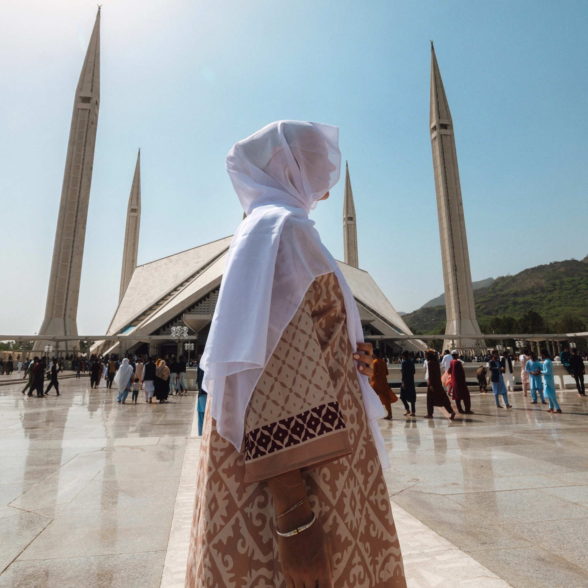 Culture in Pakistan Woman in traditional dress standing at Faisal Mosque in Islamabad, Pakistan