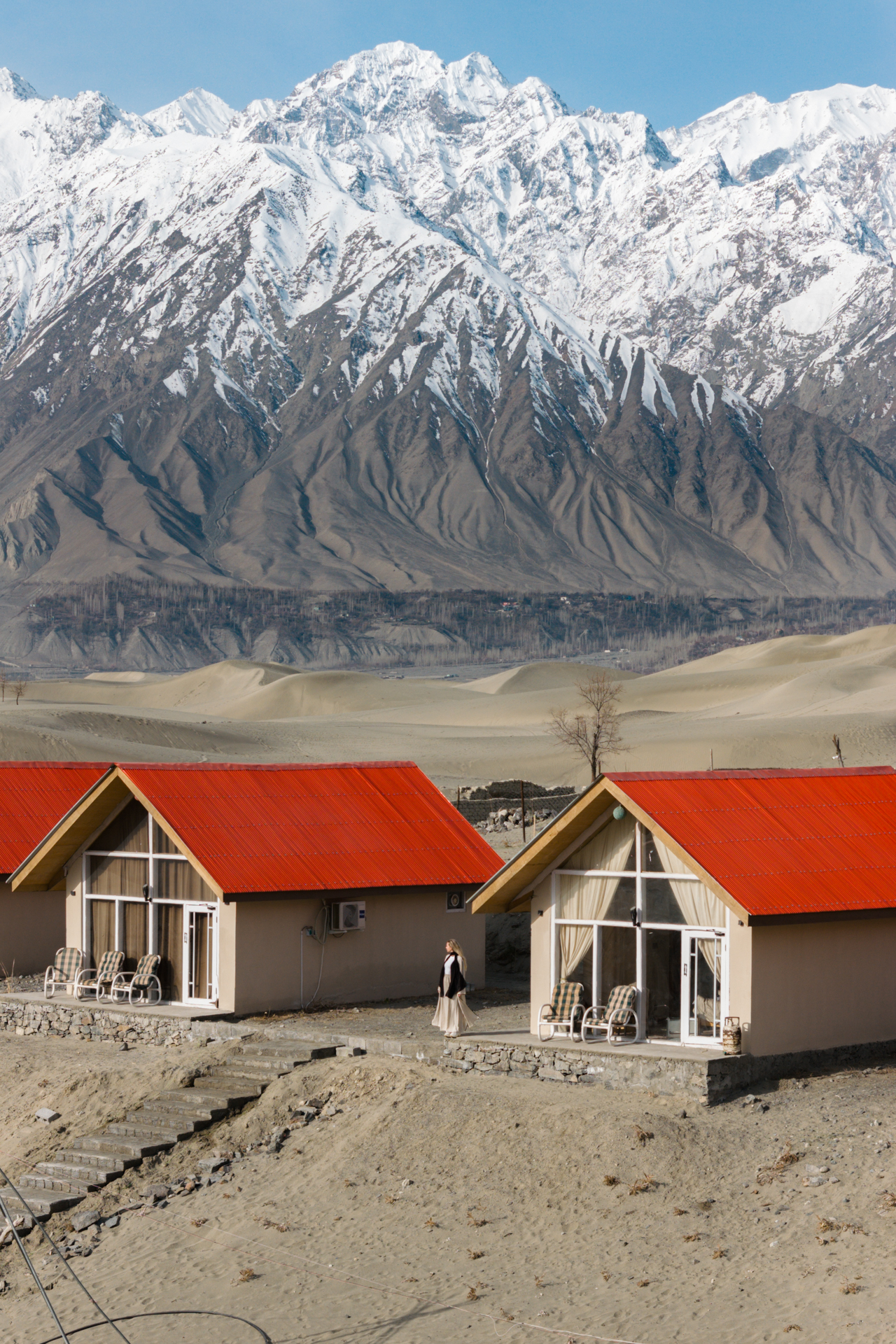 Skardu Scenic view of cottages with red roofs in Skardu’s Cold Desert, framed by snow-covered mountains in Gilgit-Baltistan, Pakistan.