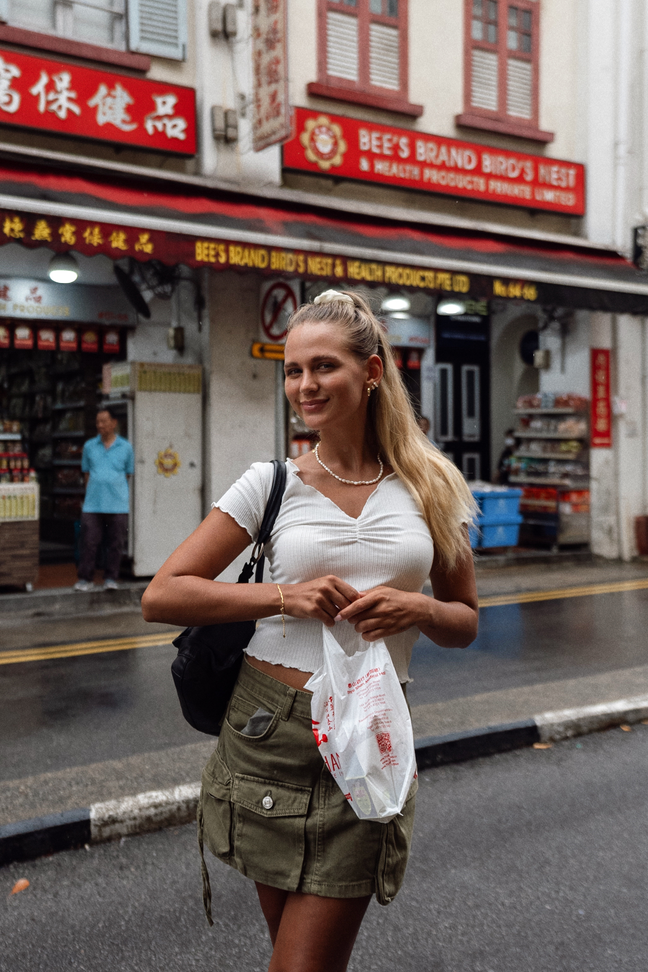 China Town Woman smiling with shopping bag in Chinatown, Singapore.