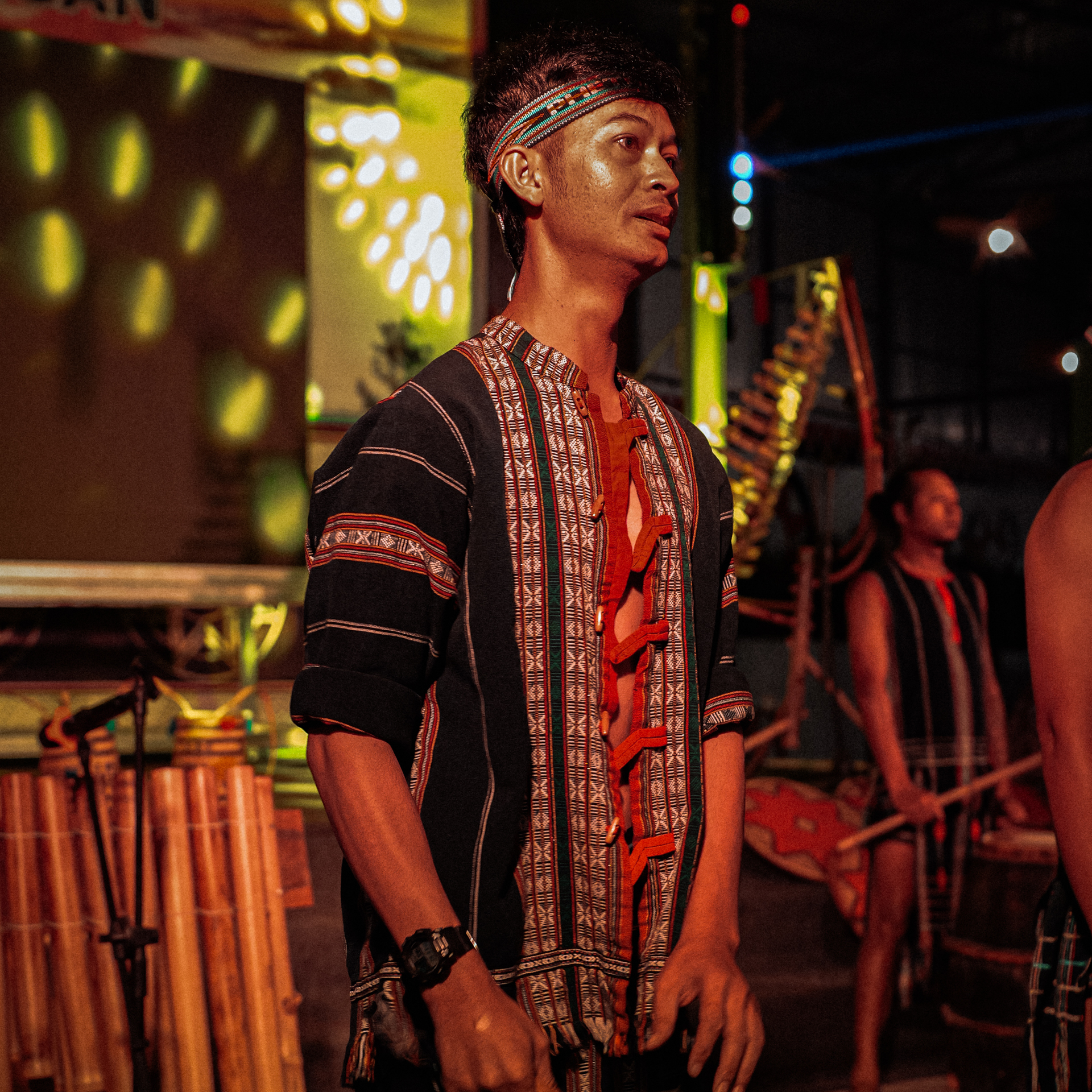 Traditions in Vietnam Man in traditional attire holding a gong during a cultural performance in Da Lat, Vietnam.